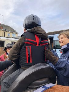 Equihandee Core Support being worn by a child on a brown pony showing 5 handles on the back 